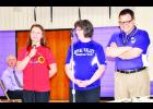 Lilly Rooks (left), a seventh-grader at Royal Valley Middle School, recently took first place in the junior documentary division at the State History Day competition for her 11-minute film “Tragedy and Greatness: The Encounters of Ron Klerk de Reus.” She will now compete at National History Day this summer. Also shown in the photo are Brenda Hainey (middle), RVMS education technology specialist; Nathan McAlister (right), RVMS history teacher; and RVMS Principal John Linn (left rear). (Photo by Ali Holcomb)