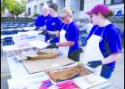 GNBank employees (from left) Jim Klingler, Audrey Kimmi, Theresa Rodecap and Kyrianna Hielscher are shown assembling the meal, which included pulled pork sandwiches, beans, chips and a drink.   
