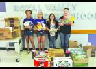 Royal Valley Middle School sixth-grade students (from left) Marissa Jackson, Sondra Priest, Paige Weddle and Jessica Marney hosted a book drive at the school to donate to KVC Kansas. KVC provides resources for foster parents in the area. 