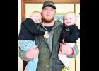 Bryce Barnett, who is an agricultural lender at The Farmers State Bank, is shown above with his two sons, Colt (at left) and Carston (at right).