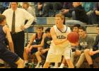 Holton junior Mason Strader (No. 5 white jersey) looks for an open teammate during the game last tuesday against Royal Valley.