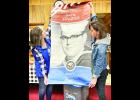 During a recent Holton/Jackson County Chamber of Commerce luncheon, Lindsay Alley (shown above at left) and Laura Golden (at right) helped display a sample of a patriotic banner that is being sold here to honor veterans.