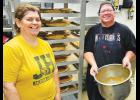 Jackson Heights food service director Carrie Harris (at left) and cook Liz Rostetter (at right) recently led an effort to bake 200 pies as a fund-raiser for the Honor Flight program at JHHS. The apple and pumpkin pies, made from scratch, netted $4,000 for the school’s June 2024 Honor Flight. (Submitted photo)
