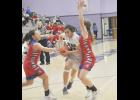 Royal Valley senior Kiikto Thomas (No. 21 in the white jersey) drives to the basket during a Panther Classic game.